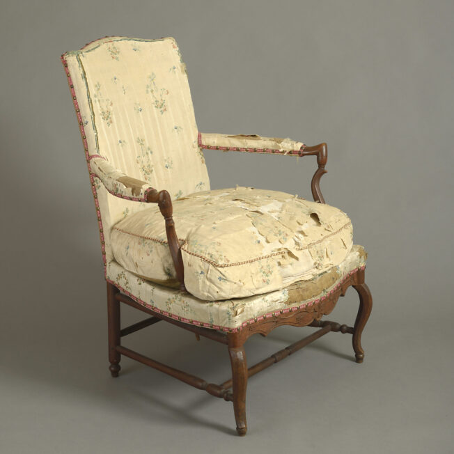 mid 18th Century French Provincial Open-Armchair. The beautifully shaped, carved cherrywood frame retaining the original rush seat (a provincial alternative to webbing) beneath the the original stuffing which was in turn covered in late 18th silk dress fabric.